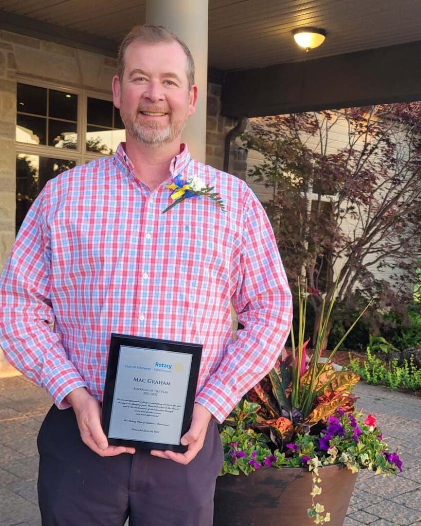 Mac Graham receiving the Rotarian of the Year award